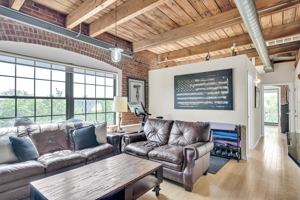 210 Broadway, Unit 301 Everett, MA 02149 - Photo 4 of 16 a living room with furniture and a large window