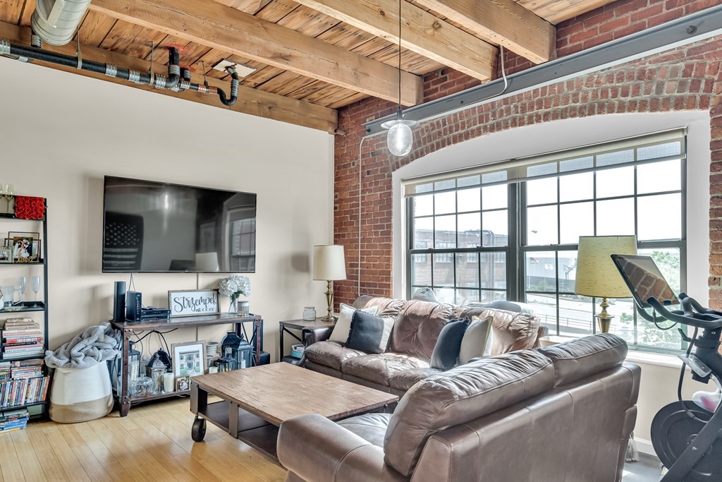 210 Broadway, Unit 301 Everett, MA 02149 - Photo 5 of 16 a living room with furniture and large windows