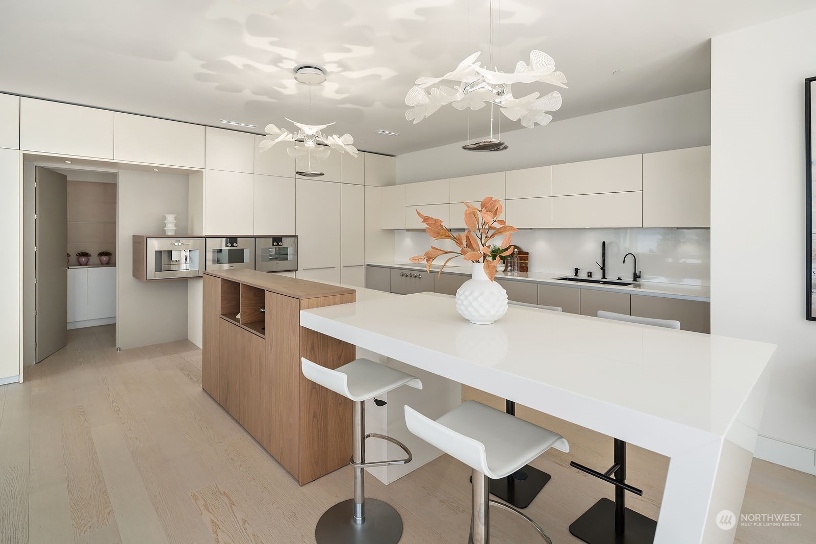 3225 Evergreen Point Road Medina, WA 98039 - Photo 9 of 34 a kitchen with a sink a stove and chairs