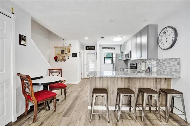 a view of a dining room with furniture and a clock