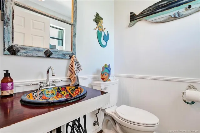 a bathroom with a toilet a sink and a mirror