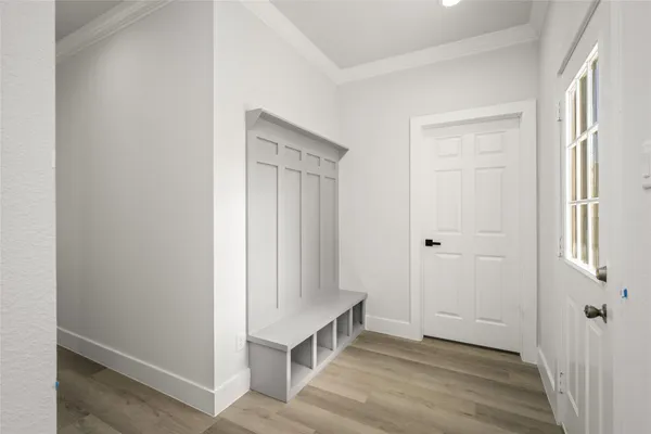 a view of an entryway with wooden floor