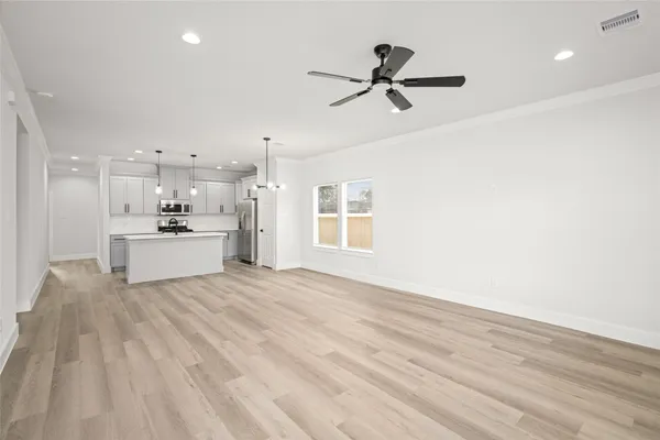 a view of a kitchen with a sink dishwasher and a refrigerator