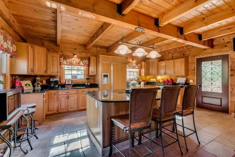 a dining table with chairs and window