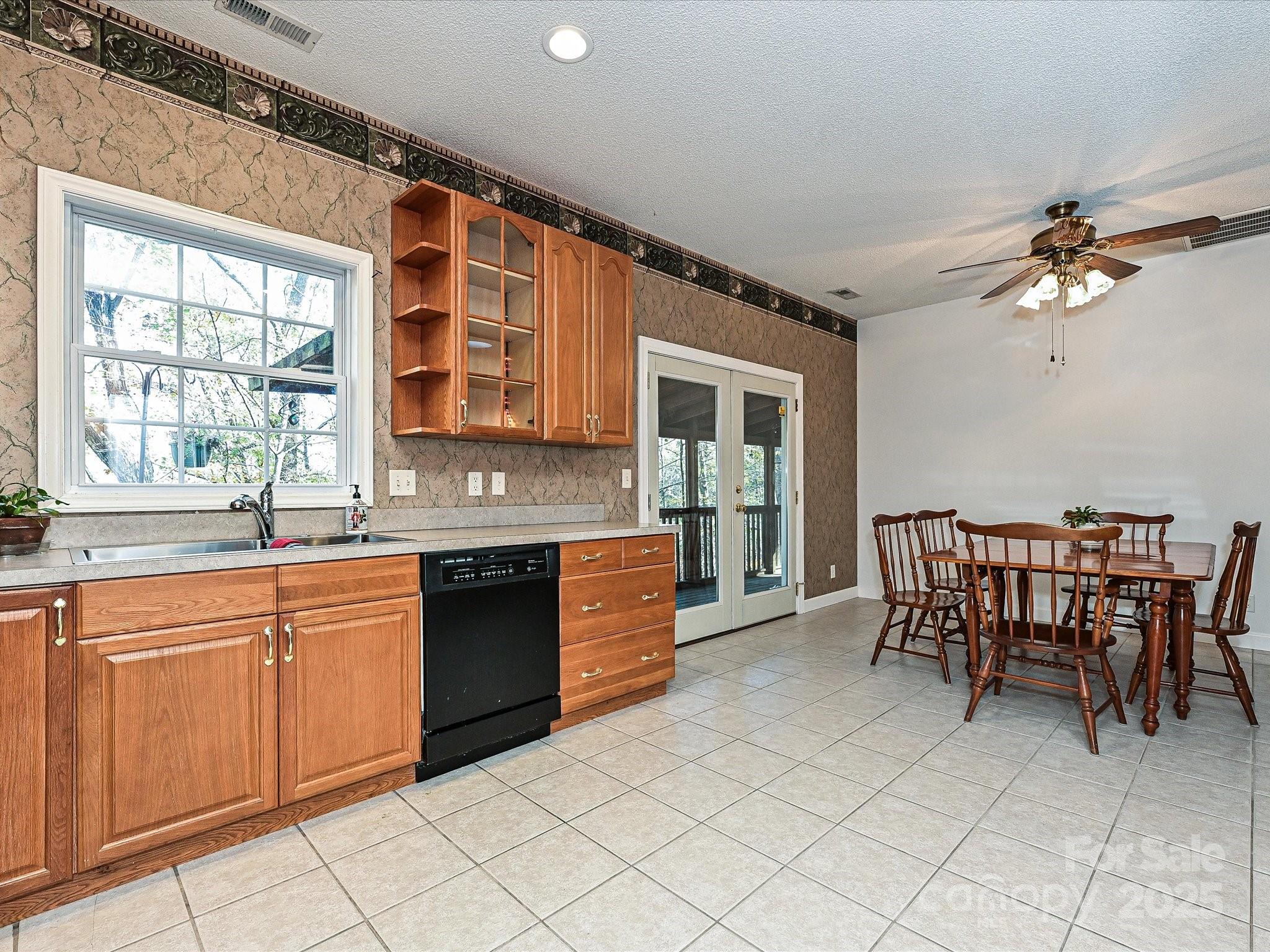 25040 Timberlake Drive Tega Cay, SC 29708 - Photo 13 of 40 a large kitchen with kitchen island granite countertop a table and chairs in it