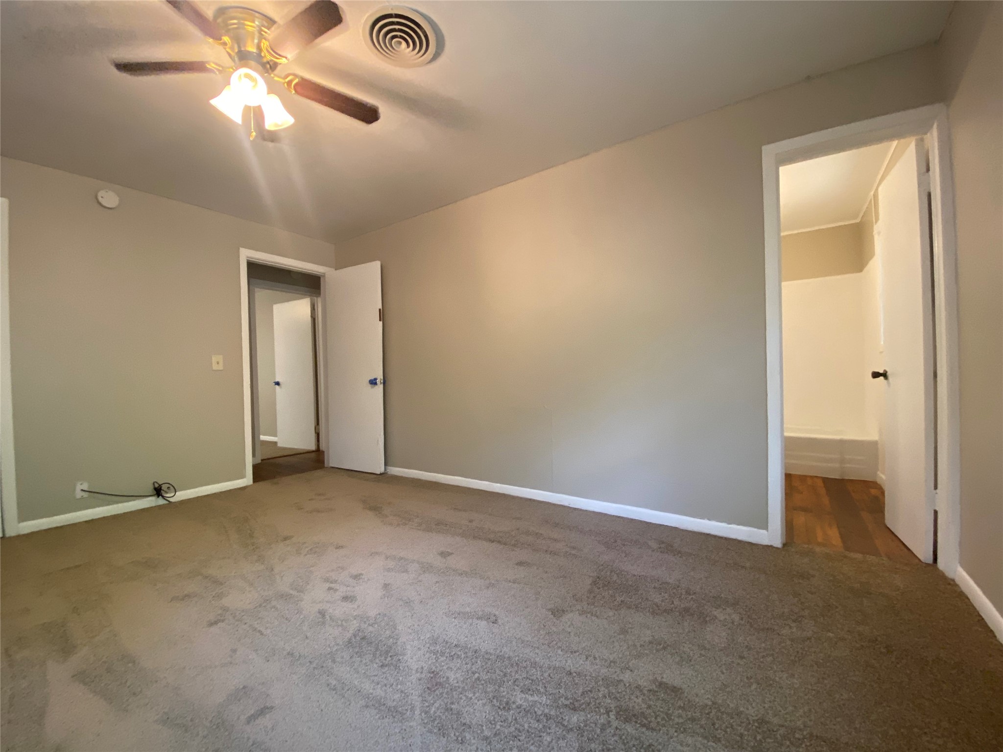 802 Mable Street El Campo, TX 77437 - Photo 11 of 15 an empty room with a ceiling fan and a window