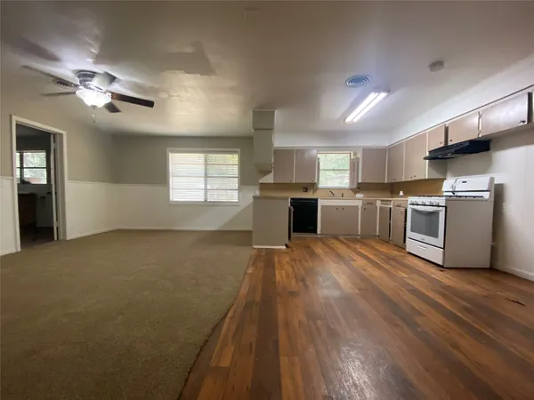 a view of a kitchen with a sink dishwasher stove and refrigerator