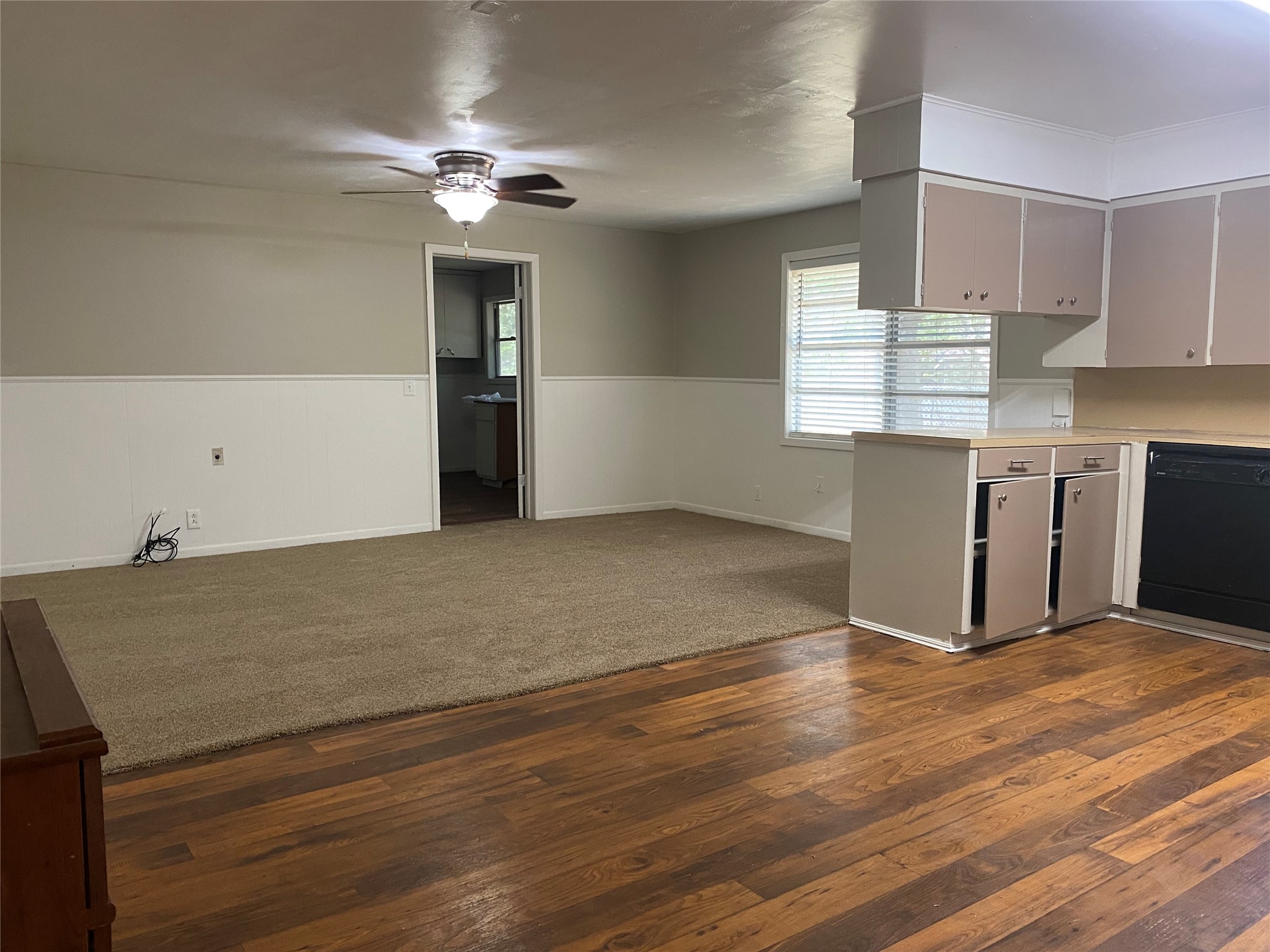 802 Mable Street El Campo, TX 77437 - Photo 7 of 15 a view of kitchen and empty room with wooden floor