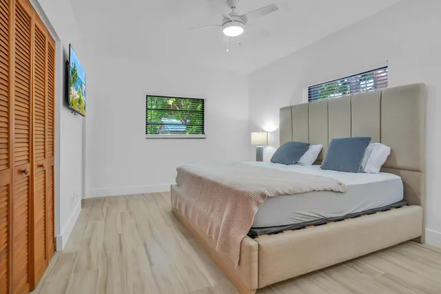 a bedroom with a bed and a lamp