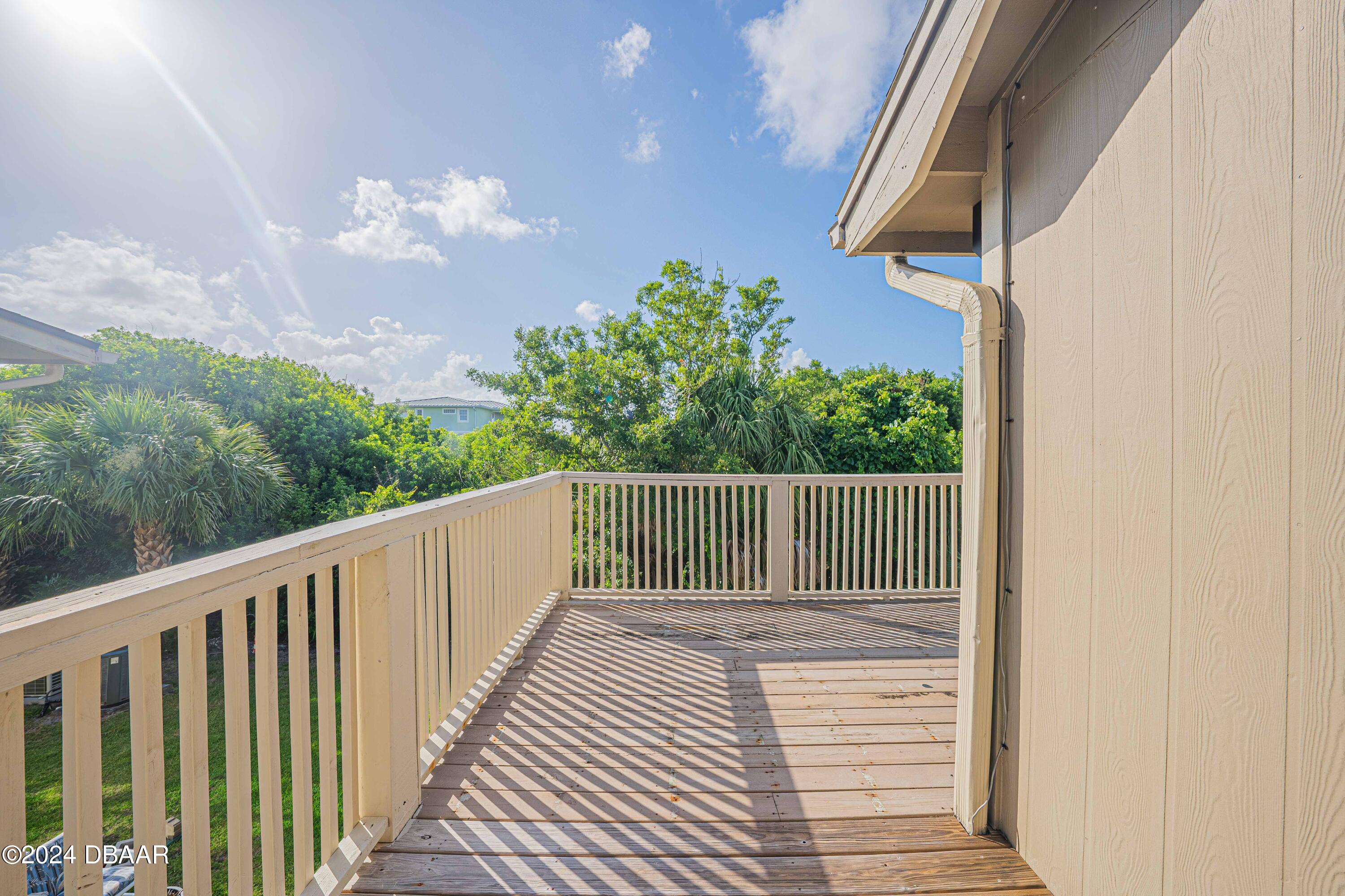 42 Jana Drive Ponce Inlet, FL 32127 - Photo 24 of 34 a balcony with wooden floor