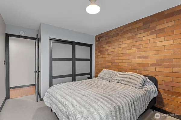 a bedroom with a bed and a wall painting