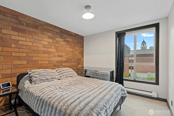 a bedroom with a bed and a window