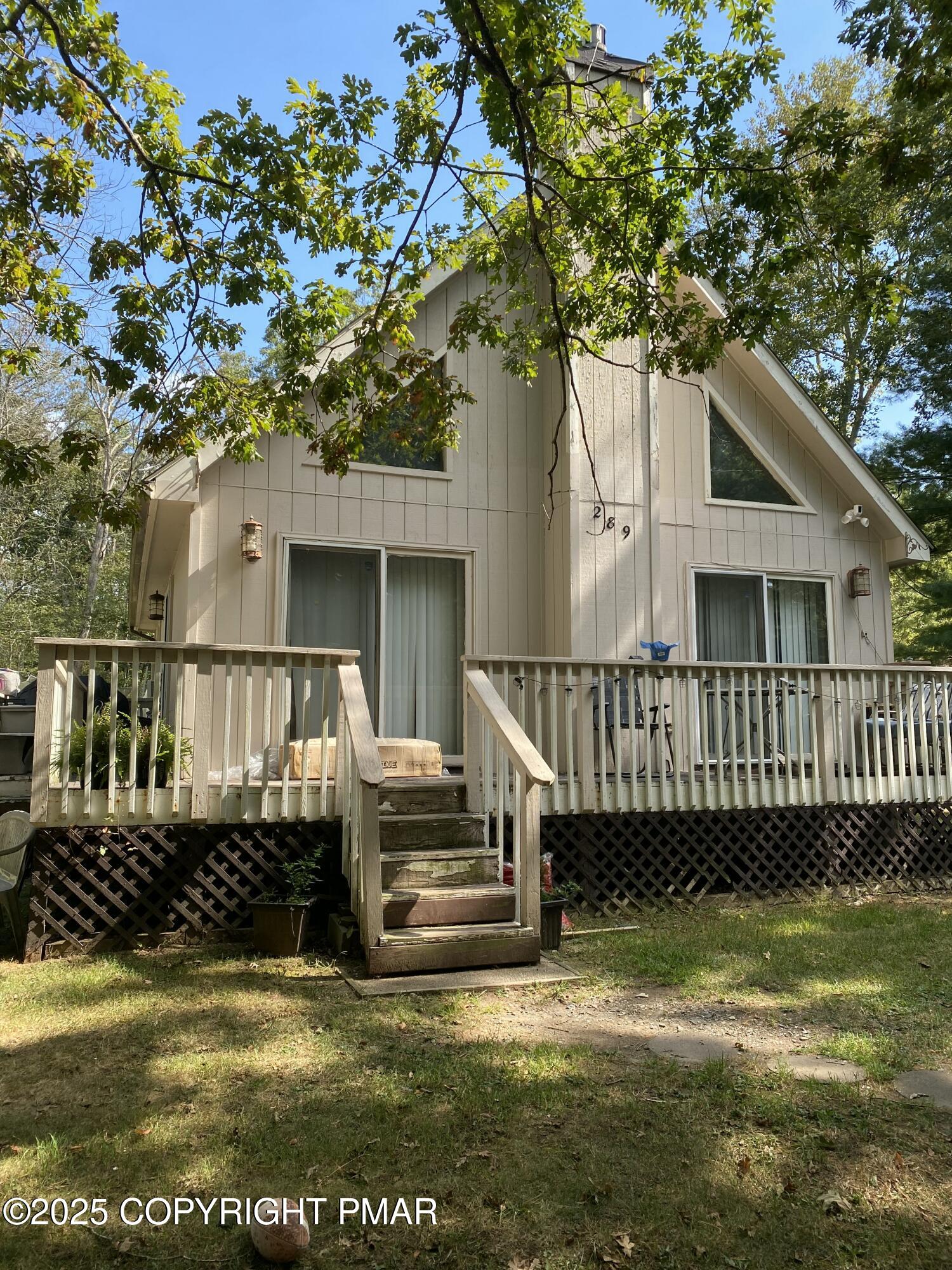 6119 Decker Road Bushkill, PA 18324 - Photo 2 of 8 a view of a house with wooden deck and a small yard