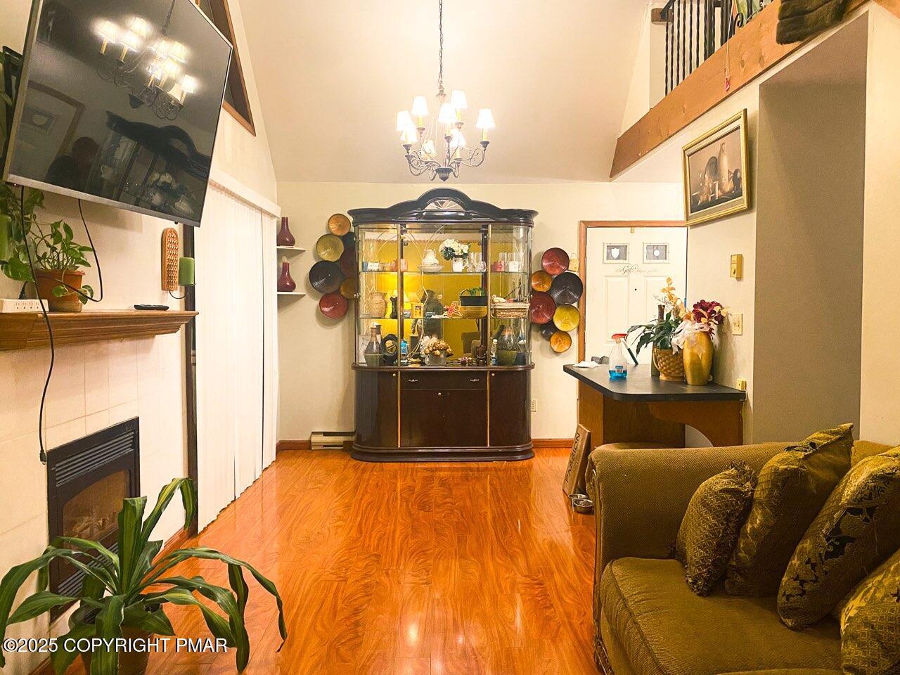 6119 Decker Road Bushkill, PA 18324 - Photo 3 of 8 a living room with a couch and a chandelier