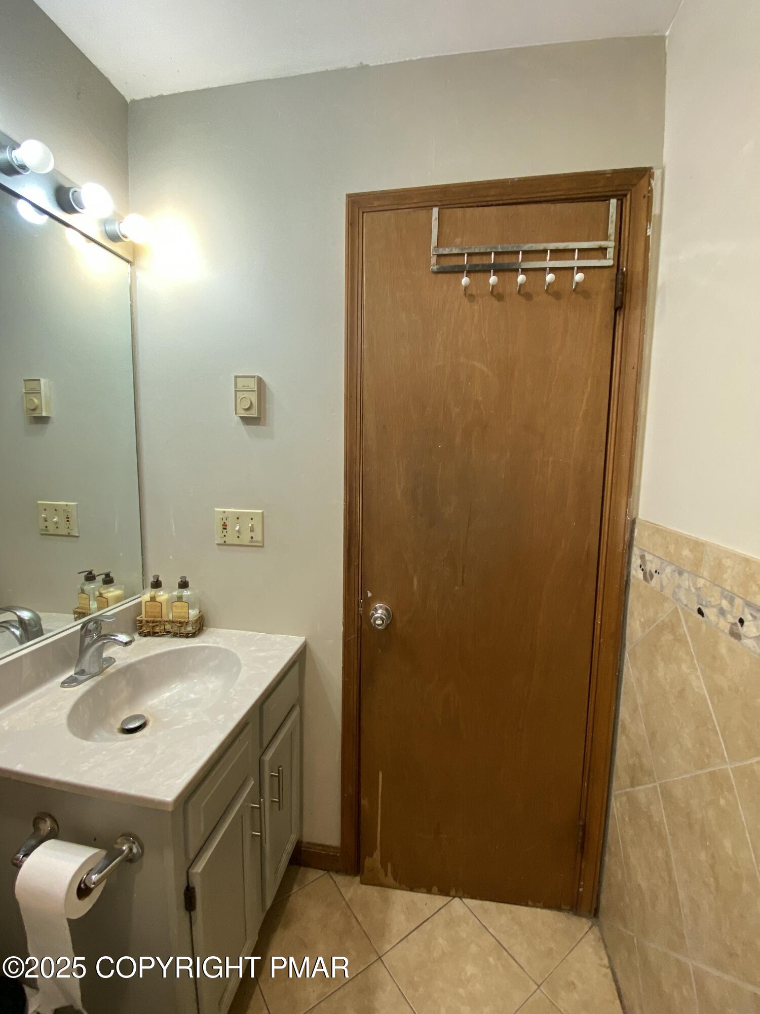 6119 Decker Road Bushkill, PA 18324 - Photo 7 of 8 a bathroom with a sink a mirror and a shower