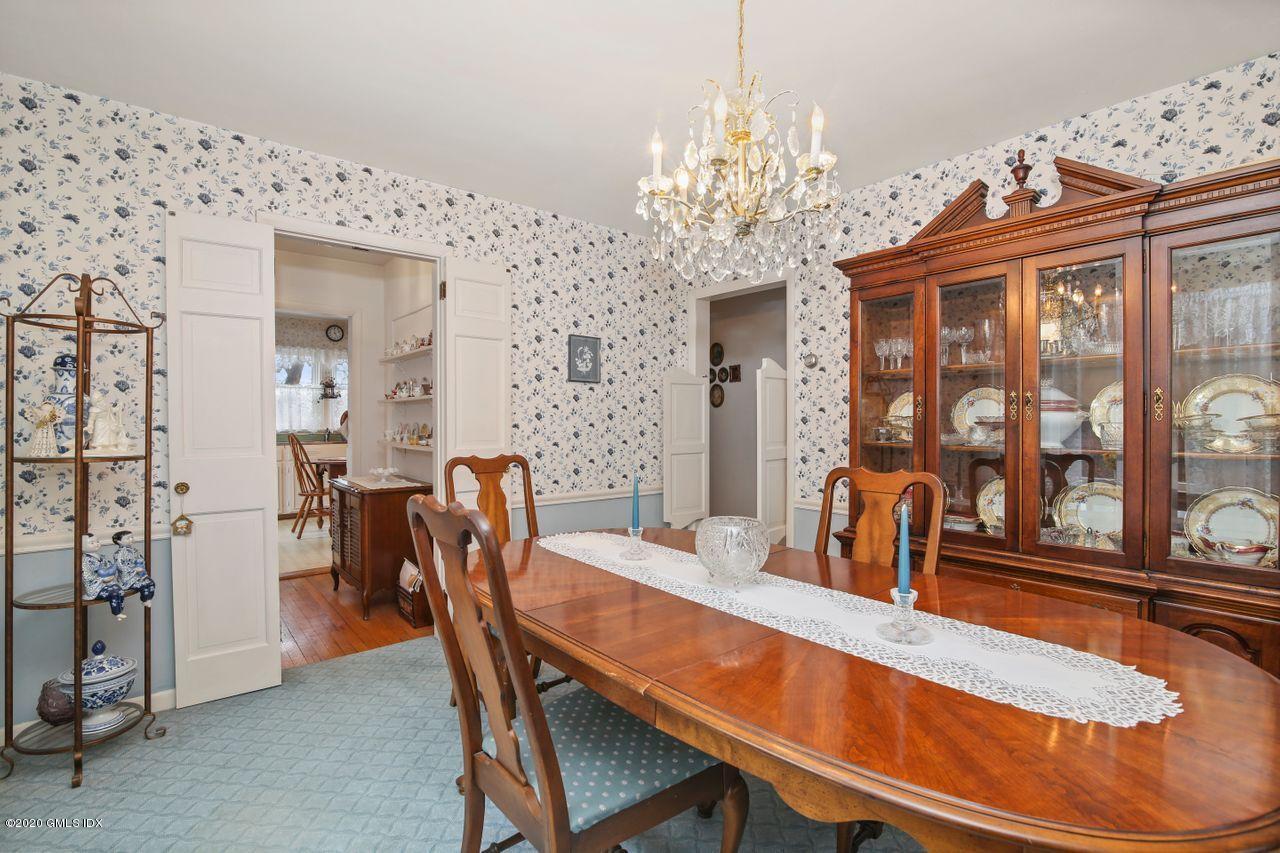 28 St Roch Avenue Greenwich, CT 06830 - Photo 4 of 15 a dining room with furniture a chandelier and window