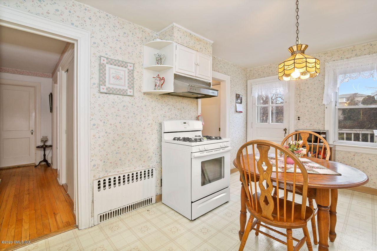 28 St Roch Avenue Greenwich, CT 06830 - Photo 7 of 15 a view of a dining room and kitchen with a table chairs