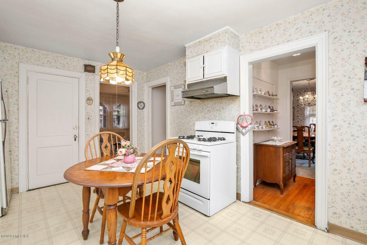 28 St Roch Avenue Greenwich, CT 06830 - Photo 8 of 15 a view of a dining room and kitchen with a table chairs