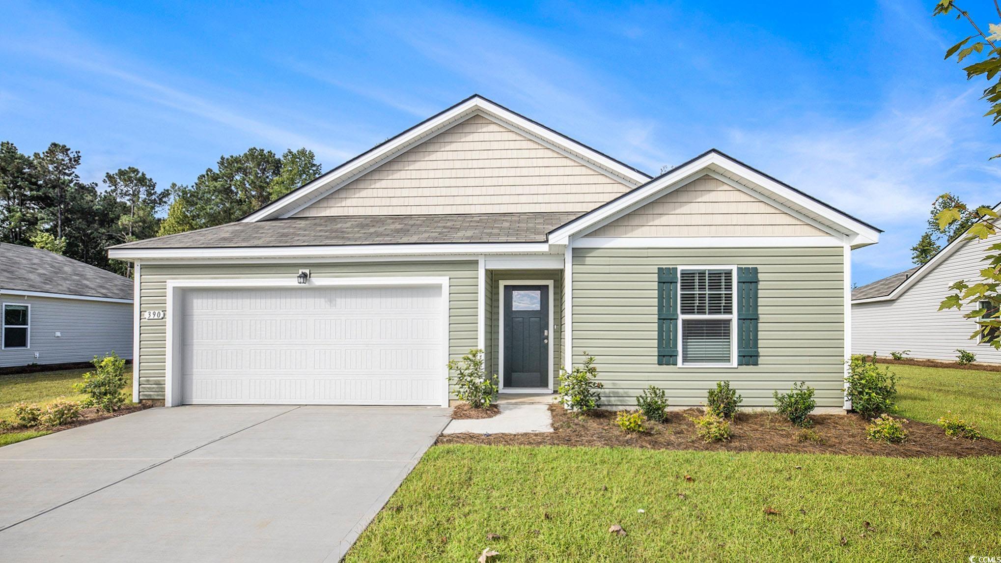 113 Homestead Way Myrtle Beach, SC 29588 - Photo 1 of 20 View of front of house featuring concrete driveway, a front lawn, and an attached garage