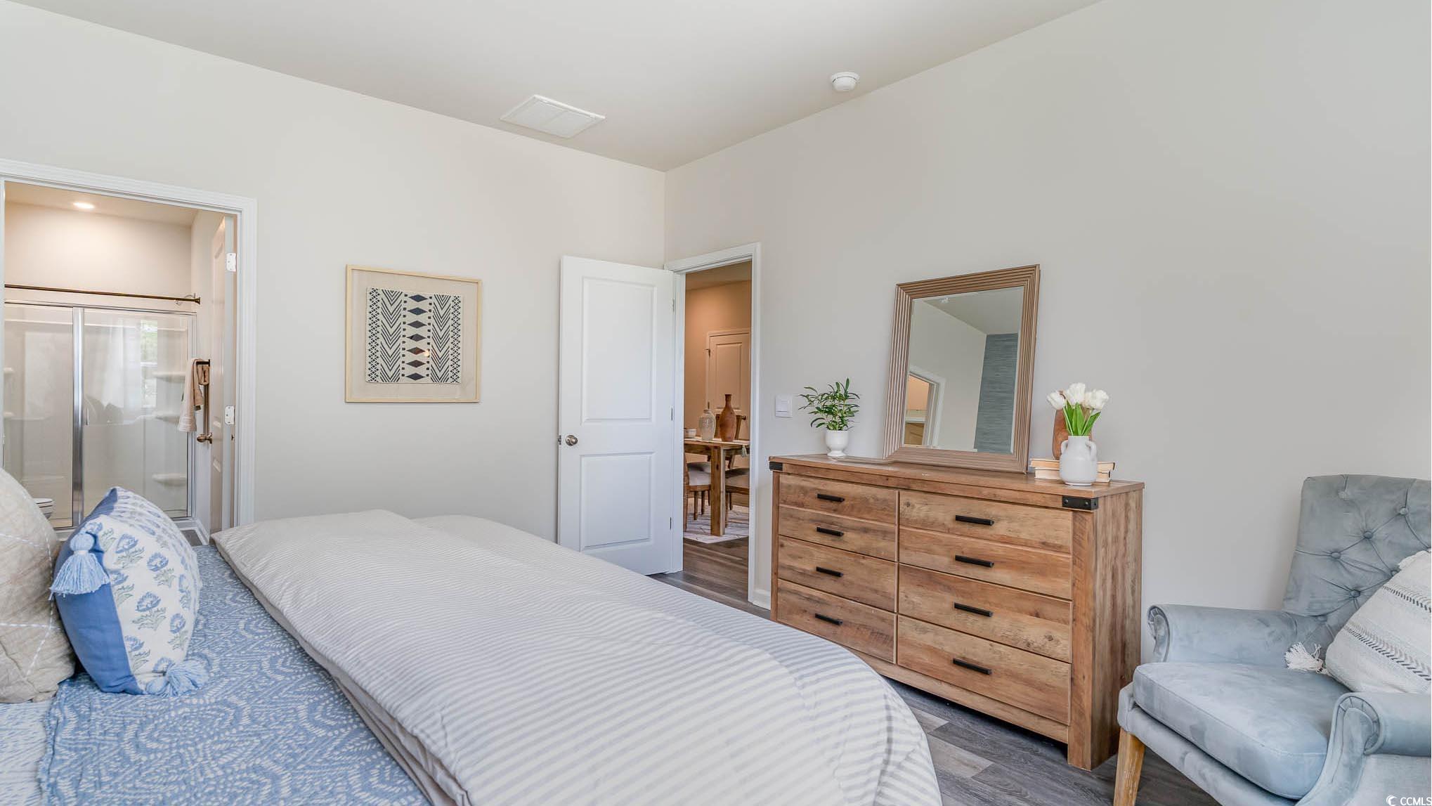 113 Homestead Way Myrtle Beach, SC 29588 - Photo 13 of 20 Bedroom with ensuite bathroom and wood finished floors