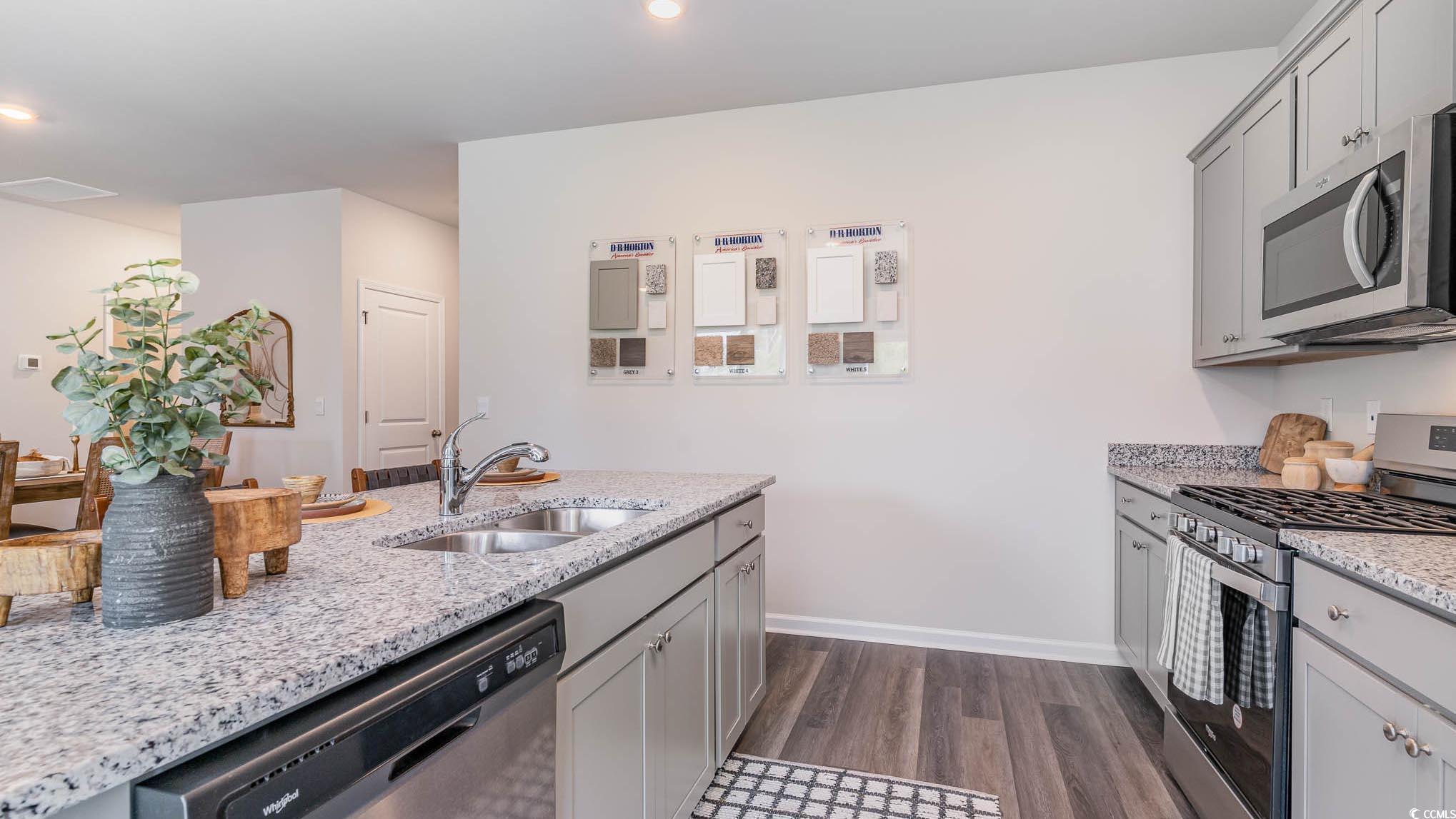 113 Homestead Way Myrtle Beach, SC 29588 - Photo 5 of 20 Kitchen with appliances with stainless steel finishes, gray cabinetry, light stone countertops, dark wood-style floors, and recessed lighting