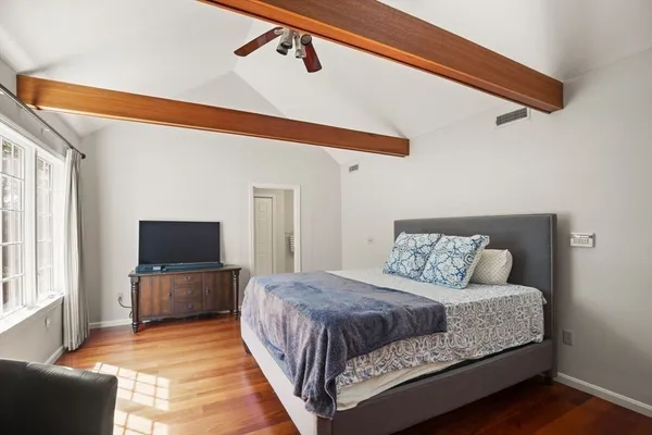 a bedroom with a bed and a window