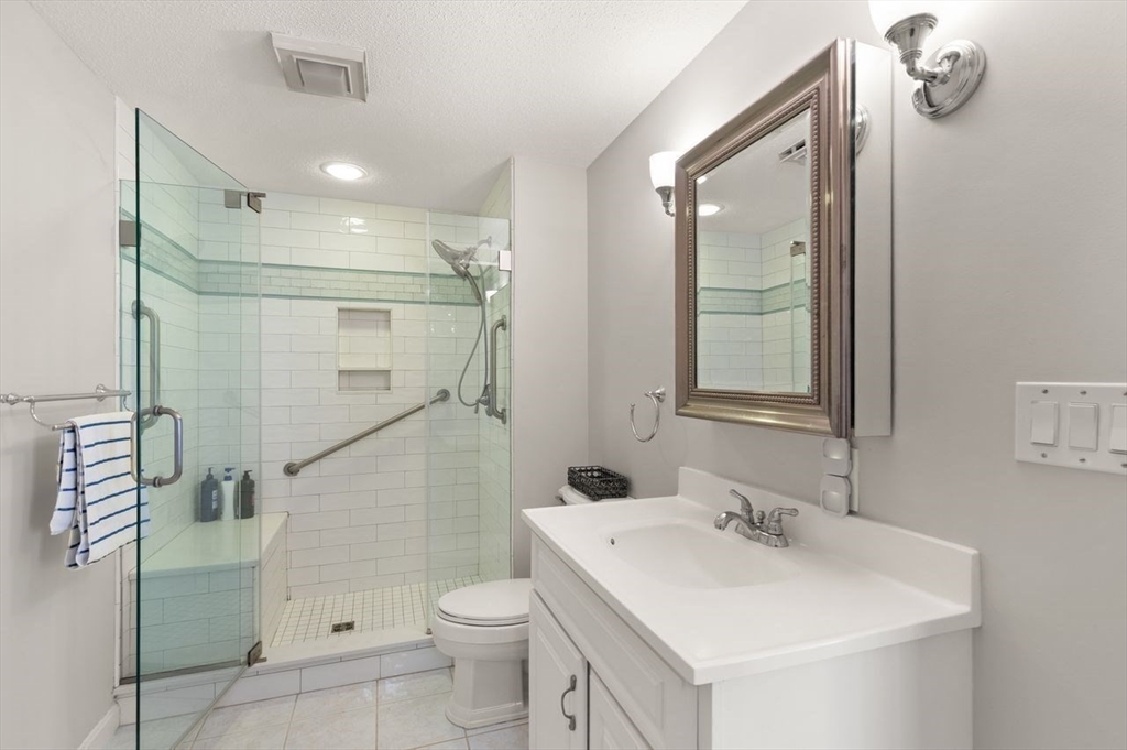 8 Bellingham Court, Unit 92 Middleton, MA 01949 - Photo 21 of 35 a bathroom with a sink a toilet and shower