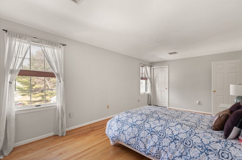 8 Bellingham Court, Unit 92 Middleton, MA 01949 - Photo 23 of 35 a bedroom with a bed and a window