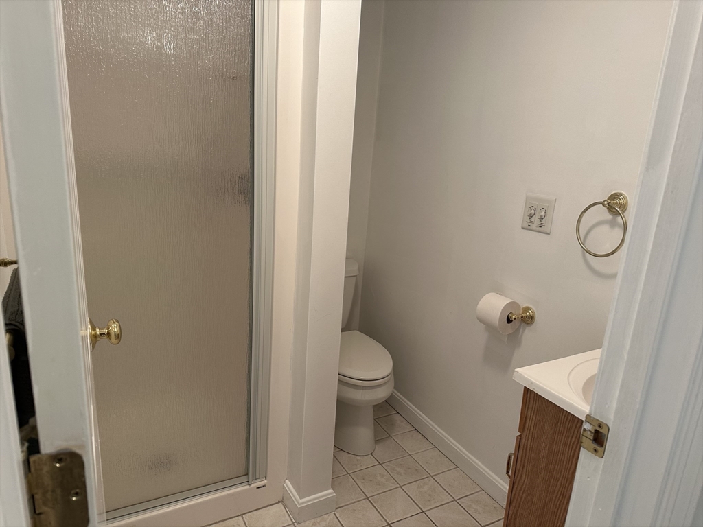 8 Bellingham Court, Unit 92 Middleton, MA 01949 - Photo 25 of 35 a white toilet sitting next to a shower