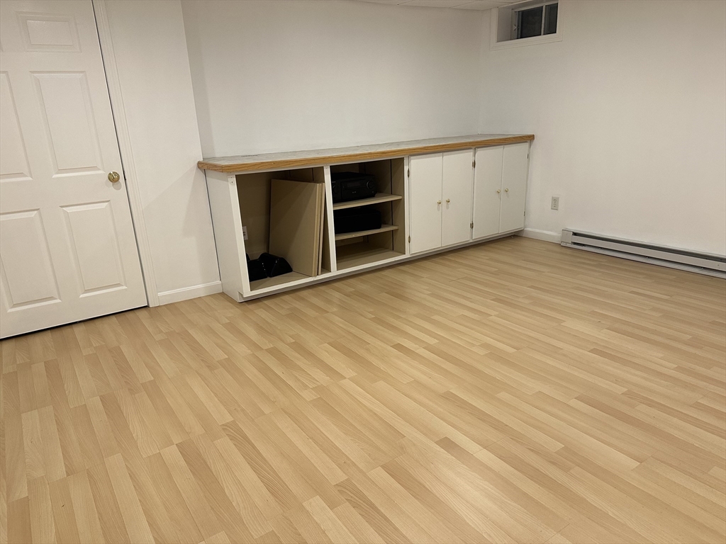 8 Bellingham Court, Unit 92 Middleton, MA 01949 - Photo 26 of 35 a view of an empty room with wooden floor