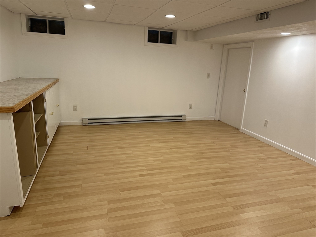 8 Bellingham Court, Unit 92 Middleton, MA 01949 - Photo 27 of 35 a view of an empty room with wooden floor
