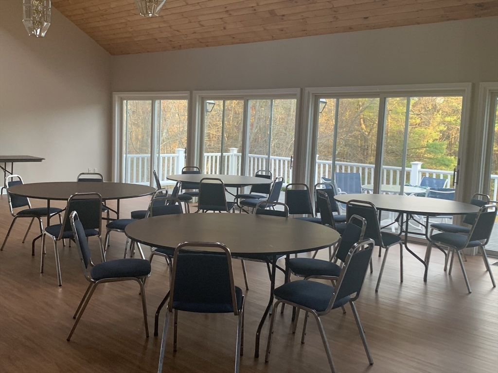 8 Bellingham Court, Unit 92 Middleton, MA 01949 - Photo 29 of 35 a view of a dining room with furniture and wooden floor