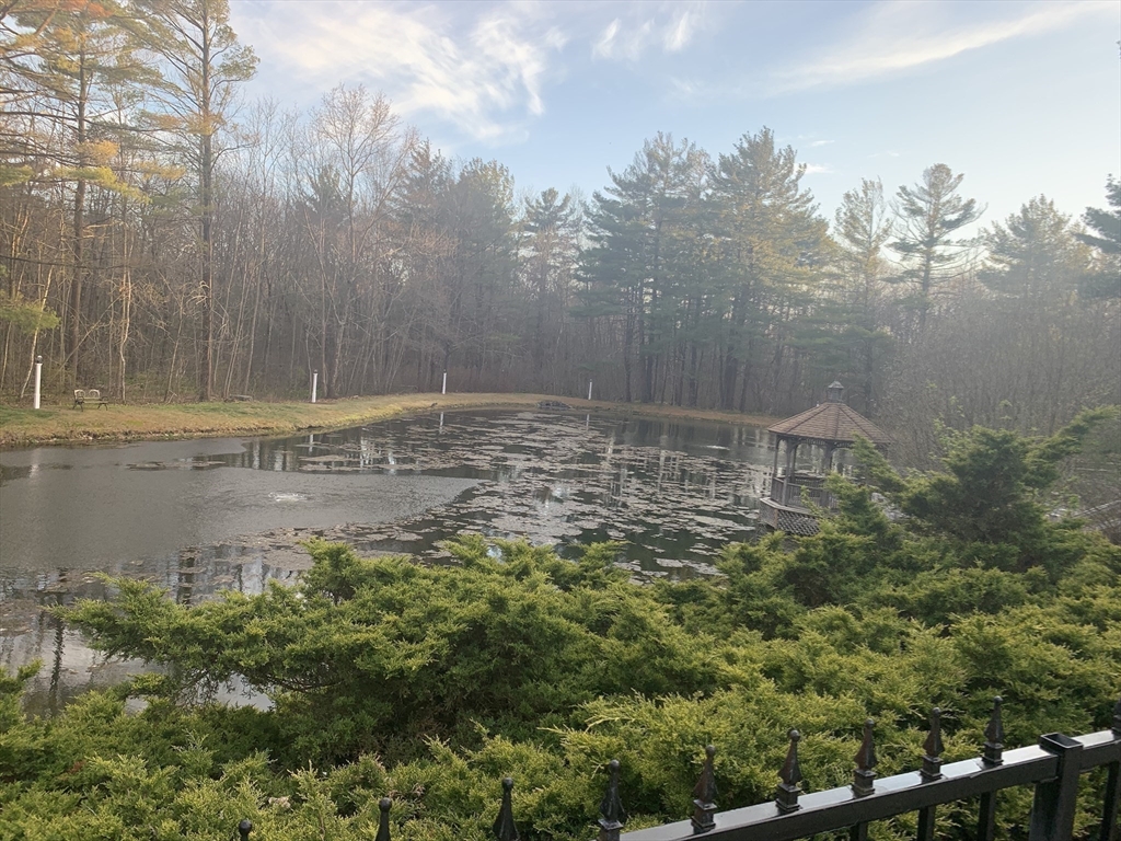8 Bellingham Court, Unit 92 Middleton, MA 01949 - Photo 33 of 35 a view of a pathway in a backyard of a house