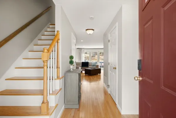 a view of entryway and hall with wooden floor