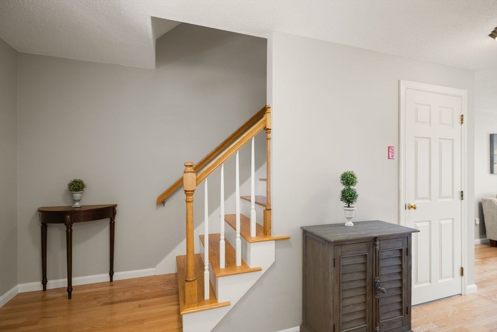 8 Bellingham Court, Unit 92 Middleton, MA 01949 - Photo 5 of 35 a view of entryway and hall with wooden floor