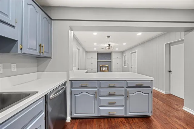 a kitchen with kitchen island a sink stainless steel appliances and cabinets
