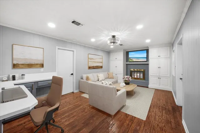 a living room with fireplace furniture and a wooden floor
