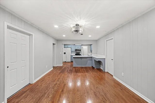 a view of kitchen with sink microwave and cabinets