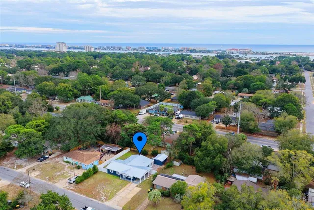 an aerial view of a house with swimming pool and deck area