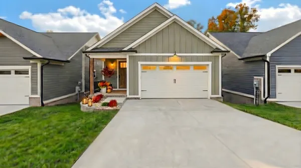 a front view of a house with a yard and garage