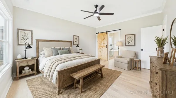 a bedroom with a large bed and a chandelier