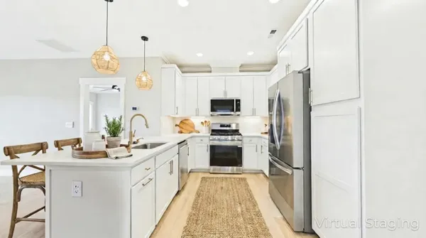 a kitchen with white cabinets and stainless steel appliances
