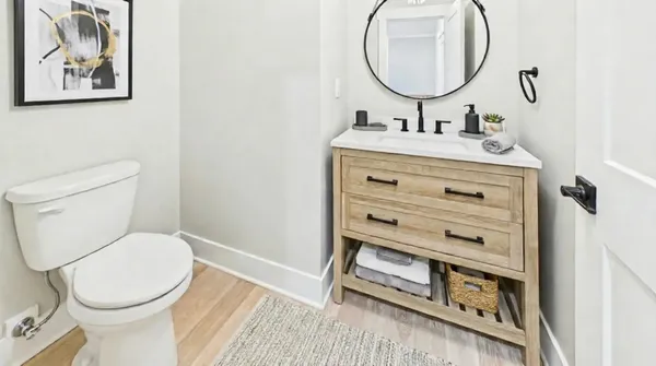 a bathroom with a toilet a sink and mirror