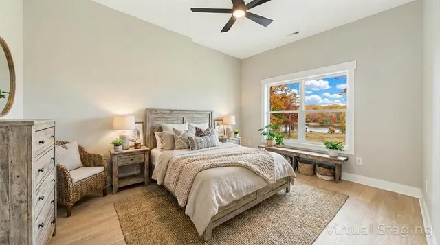 a bedroom with a bed and wooden floor
