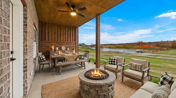 a view of a patio with dining table and chairs with a yard