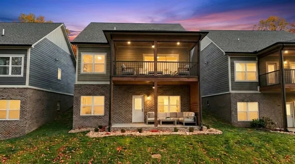 a kitchen with stainless steel appliances granite countertop a sink a stove top oven a refrigerator a microwave oven with white cabinets and wooden floor