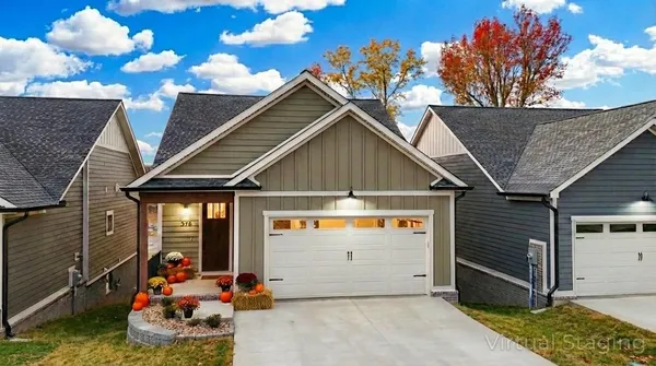 a living room with furniture a large window and a table