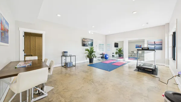 a spacious bathroom with double vanity and a mirror