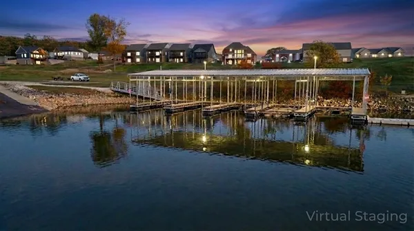 a view of a patio with furniture and a lake view