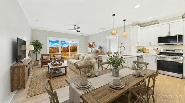 a view of a dining room with furniture a kitchen and chandelier